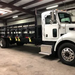 Heavy-duty custom stake bed fabricated by Texas DPF & Services' metal specialists